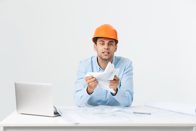 Young workman annoyed angry in furious gesture. Negative expression on white grey background.