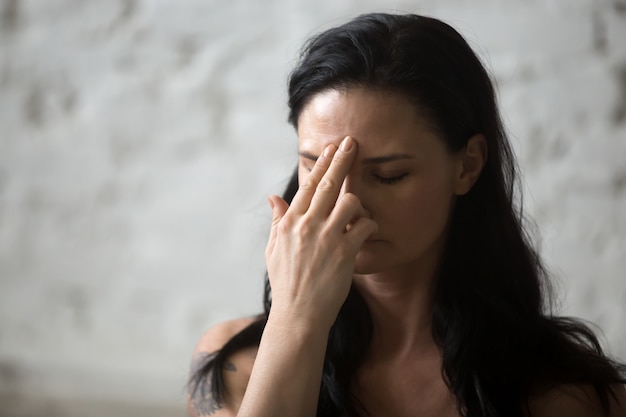 Young yogi attractive woman using Alternate Nostril Breathing yo