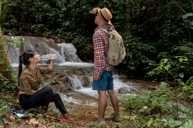 Young and young men and hikers are drinking fresh water.