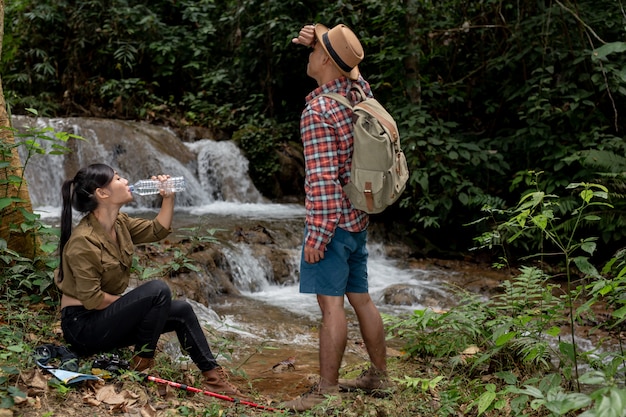 Young and young men and hikers are drinking fresh water.