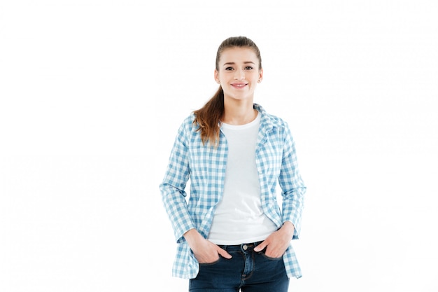 Young young woman posing over white wall