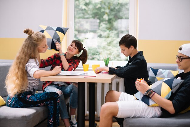 Youngsters hanging out at table