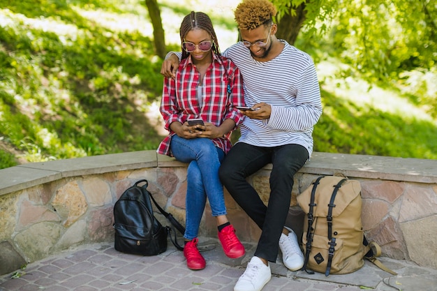 Youngsters using smartphones in park