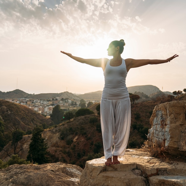 Foto gratuita giovane donna, yoga, natura e tramonto