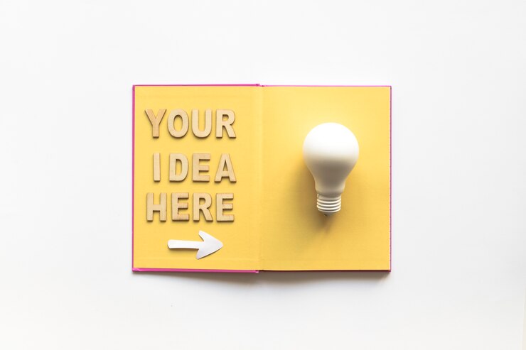 Free Photo your idea here text with arrow symbol showing white light bulb on book