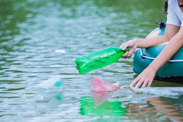 Youth collect garbage in the river, concept of National Youth Day and World Environment Day.