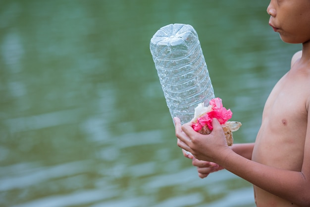 Free photo youth collect garbage in the river, concept of national youth day and world environment day.