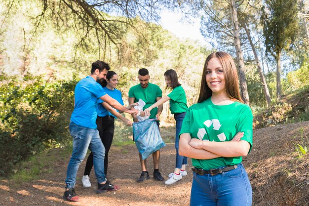 Youth folding trash in forest