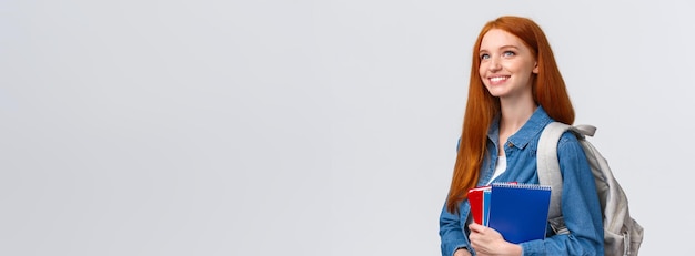 Free photo youth teenagers and education concept determined goodlooking dreamy and upbeat smiling redhead femal