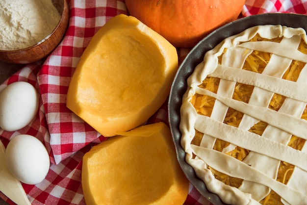 Yummy apple pie with halved pumpkins