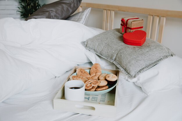 Yummy breakfast and presents on bed