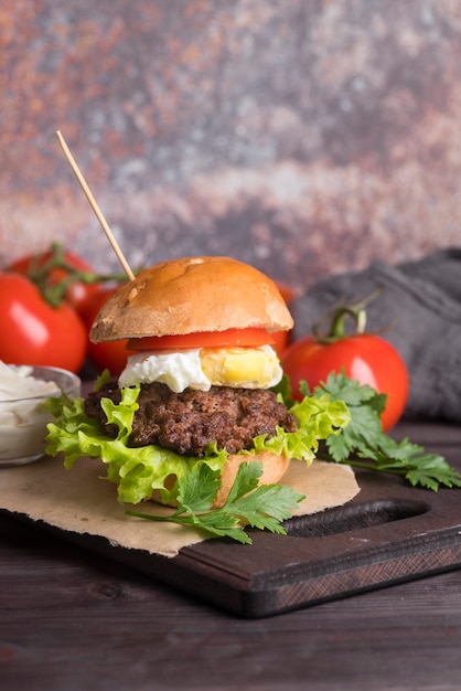 Yummy burger with tomatoes and salad