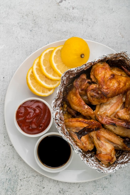 Yummy chicken wings with lemon and ketchup