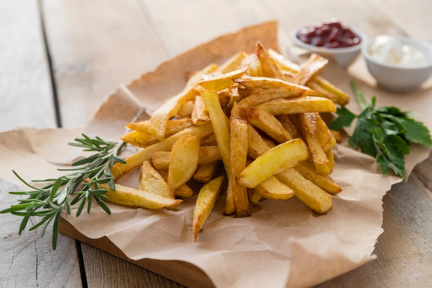 Yummy french fries on wooden table