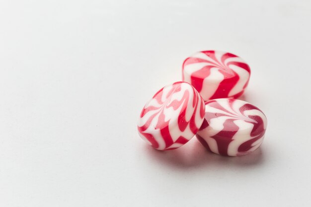 Yummy little candies on white table