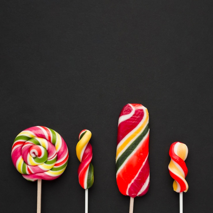 Free Photo yummy lollipops on a black table