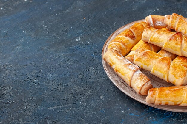 yummy sweet bangles with filling inside plate on dark desk