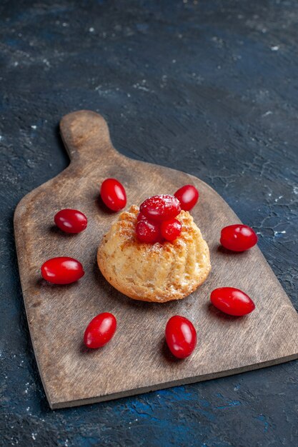 yummy sweet cake with red dogwoods on dark-grey fruit berry color cake biscuit