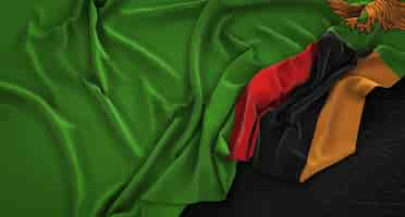 Free photo zambia flag wrinkled on dark background 3d render