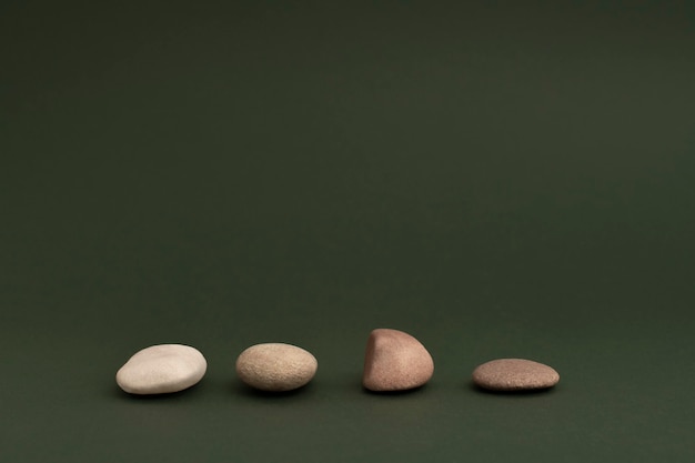 Zen stones stacked on green background in health and wellbeing concept