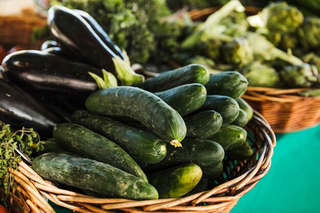 Zucchini and eggplant in wicker basket for sale in supermarket