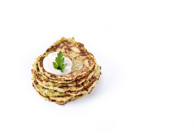 Zucchini fritters with yogurt sauce isolated on white background Vegetable pancakes