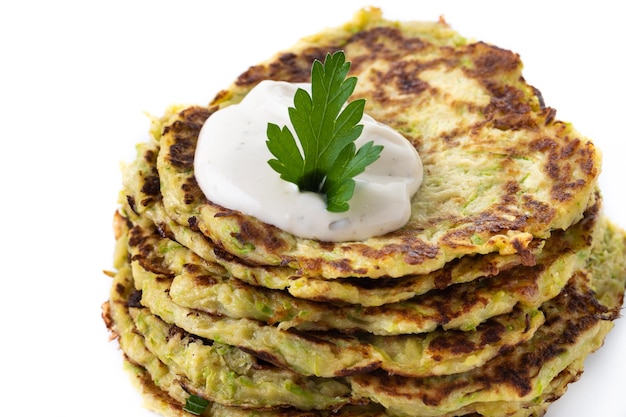 Zucchini fritters with yogurt sauce isolated on white background