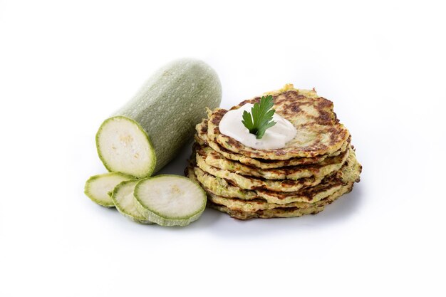 Zucchini fritters with yogurt sauce isolated on white background