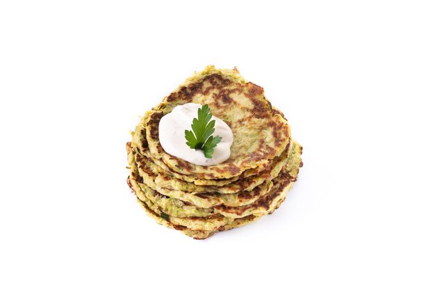 Zucchini fritters with yogurt sauce isolated