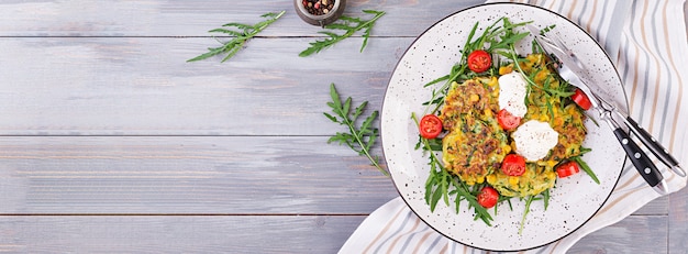 Zucchini pancakes with corn and sour cream