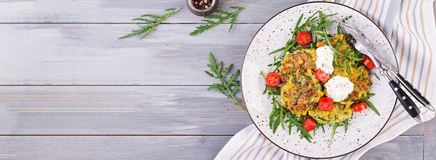 Zucchini pancakes with corn and sour cream