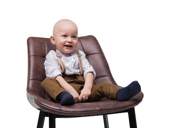 Free PSD adorable baby boy sitting on chair