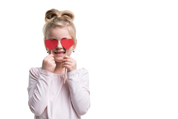 Adorable girl with heart shaped candy