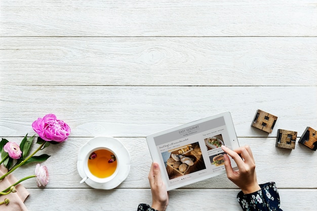 Aerial view of a woman using digital tablet cooking hobby concept