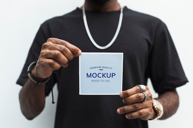 African man holding a photo paper mockup