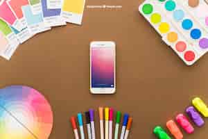 Free PSD art concept with smartphone and pencils