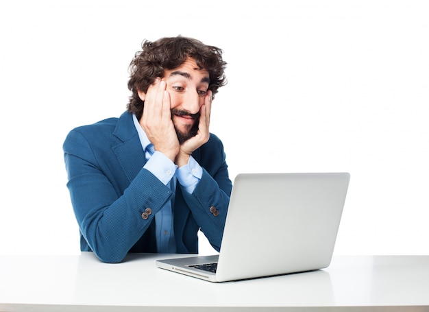 Astonished employee looking at his laptop