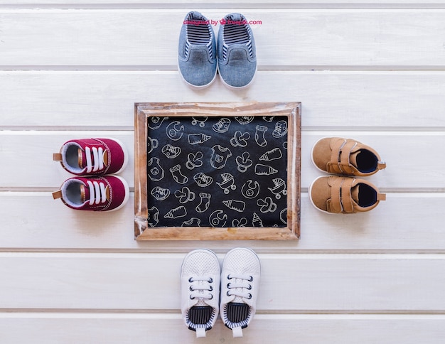 Free PSD baby mockup with four pairs of shoes