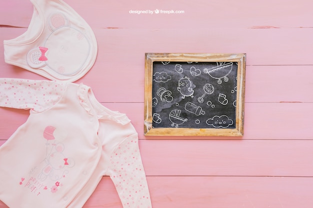 Free PSD baby mockup with pink clothes