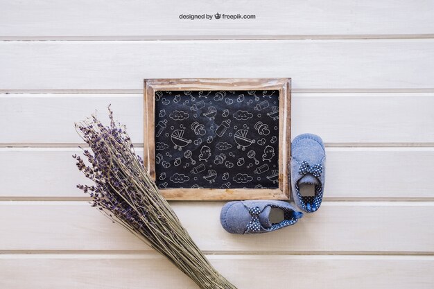 Baby mockup with slate and flower