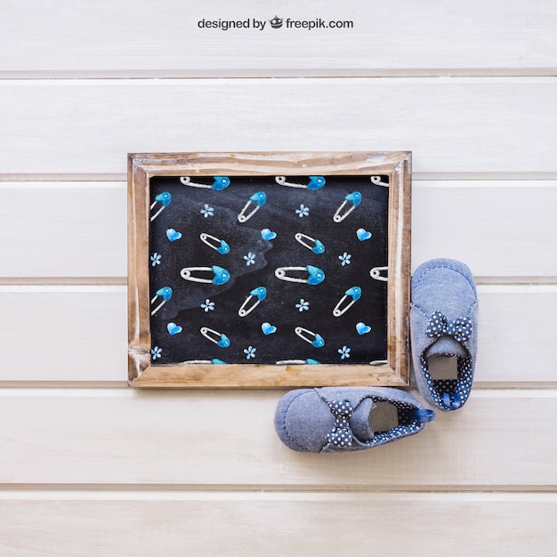 Baby mockup with slate and shoes