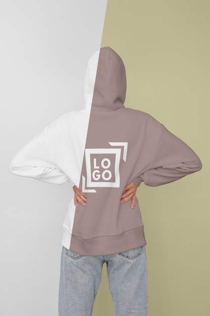 Back view of stylish woman in hoodie