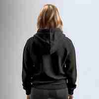 Free PSD back view of a young woman in black hoodie on grey background