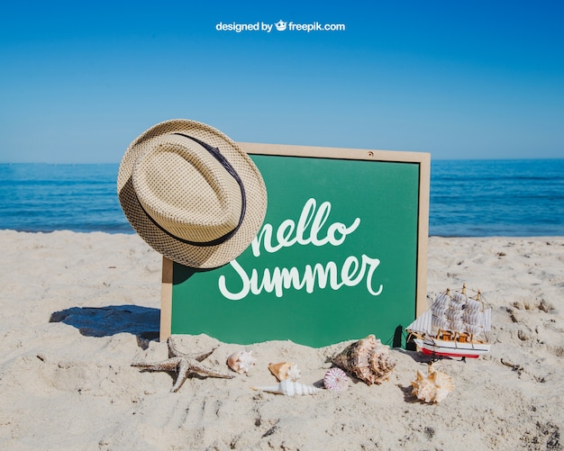 Beach concept with hat hanging on slate