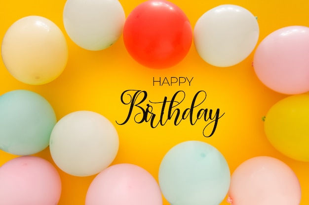 Birthday background with colorful balloons on yellow