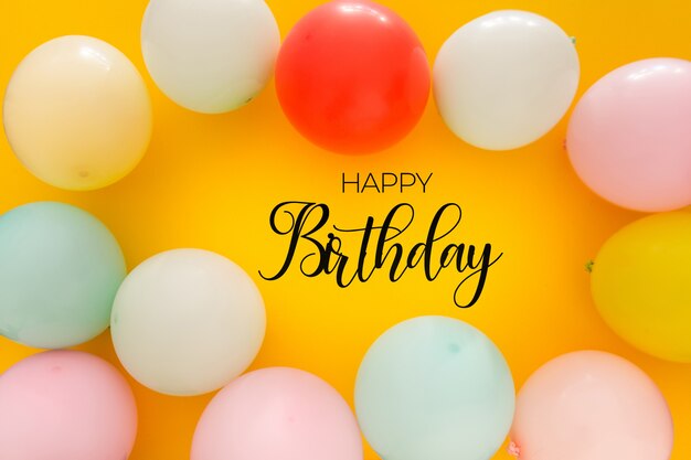 Birthday background with colorful balloons on yellow