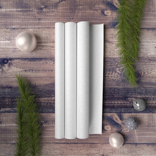 Blank paper on wooden table surrounded by baubles and pines