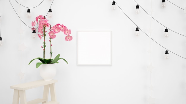 白い壁と美しい装飾的なピンクの花に掛かっているランプと空白のフォトフレームモックアップ