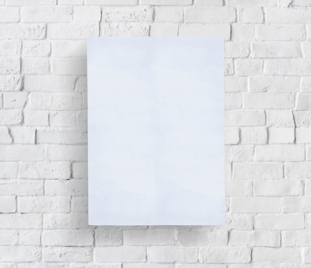 blank poster in front of brick wall