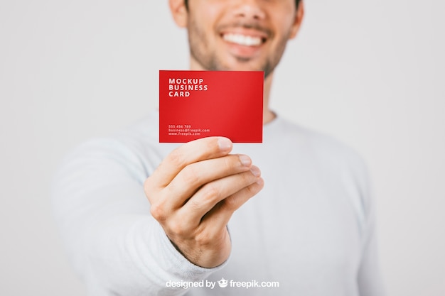 Blurred man with business card in foreground